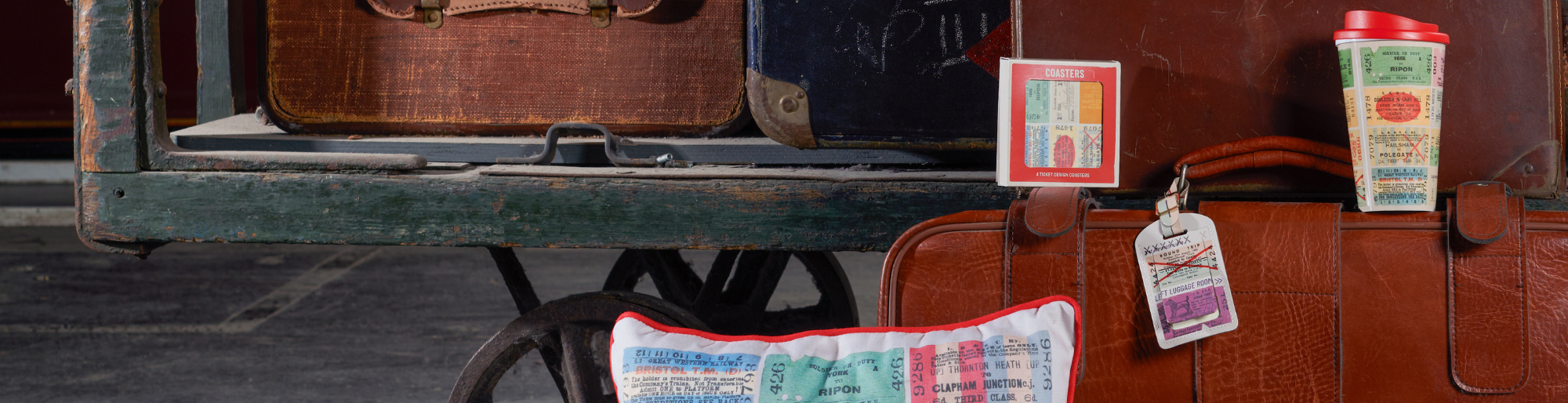 green toy train next to blue caps and t-shirt 