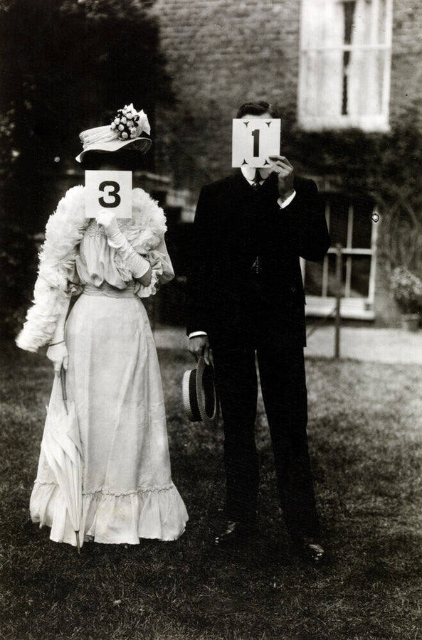 A couple, each holding up a number in front of their face circa 1905 Art Print - Science Museum Shop