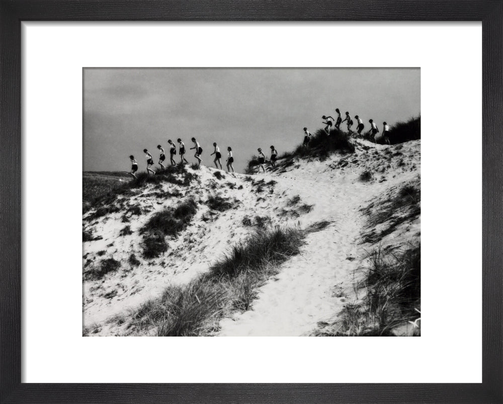 Horizon line of women walking over dunes, about 1930. art print extra small black Art Print - Science Museum Shop