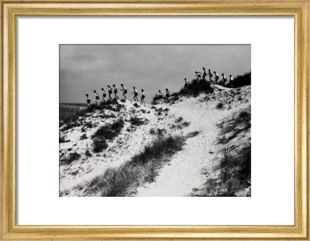 Horizon line of women walking over dunes, about 1930. art print small gold Art Print - Science Museum Shop