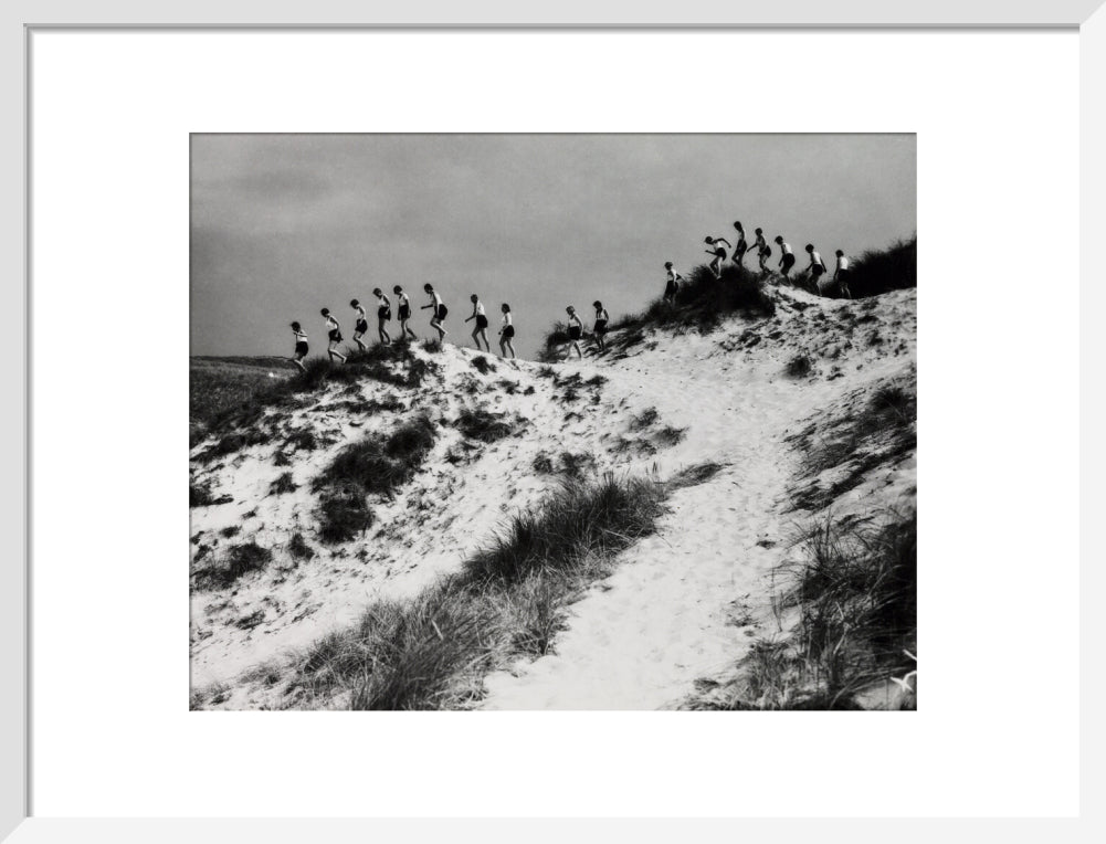 Horizon line of women walking over dunes, about 1930. art print medium white Art Print - Science Museum Shop