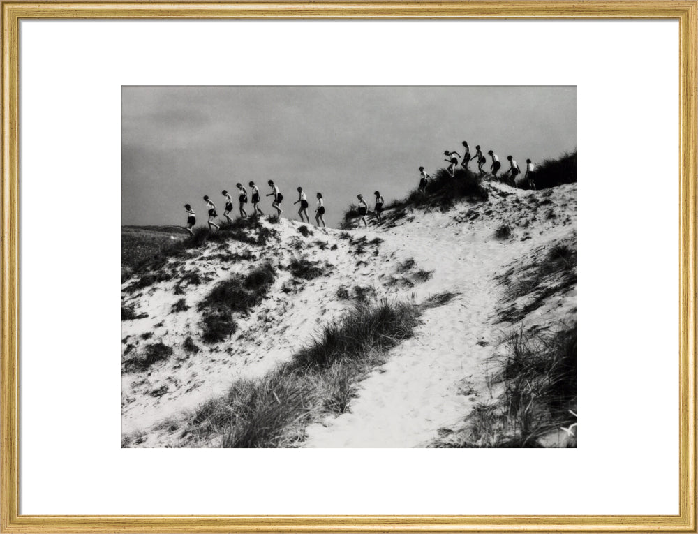 Horizon line of women walking over dunes, about 1930. art print large gold Art Print - Science Museum Shop