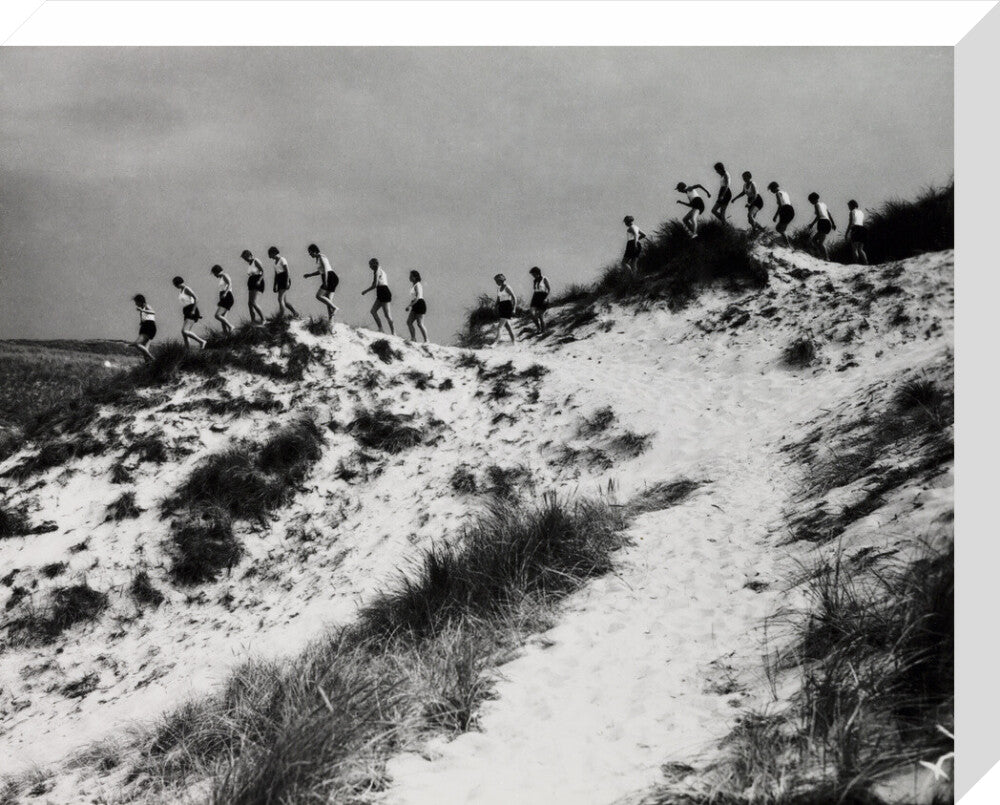 Horizon line of women walking over dunes, about 1930. stretched canvas medium none Art Print - Science Museum Shop
