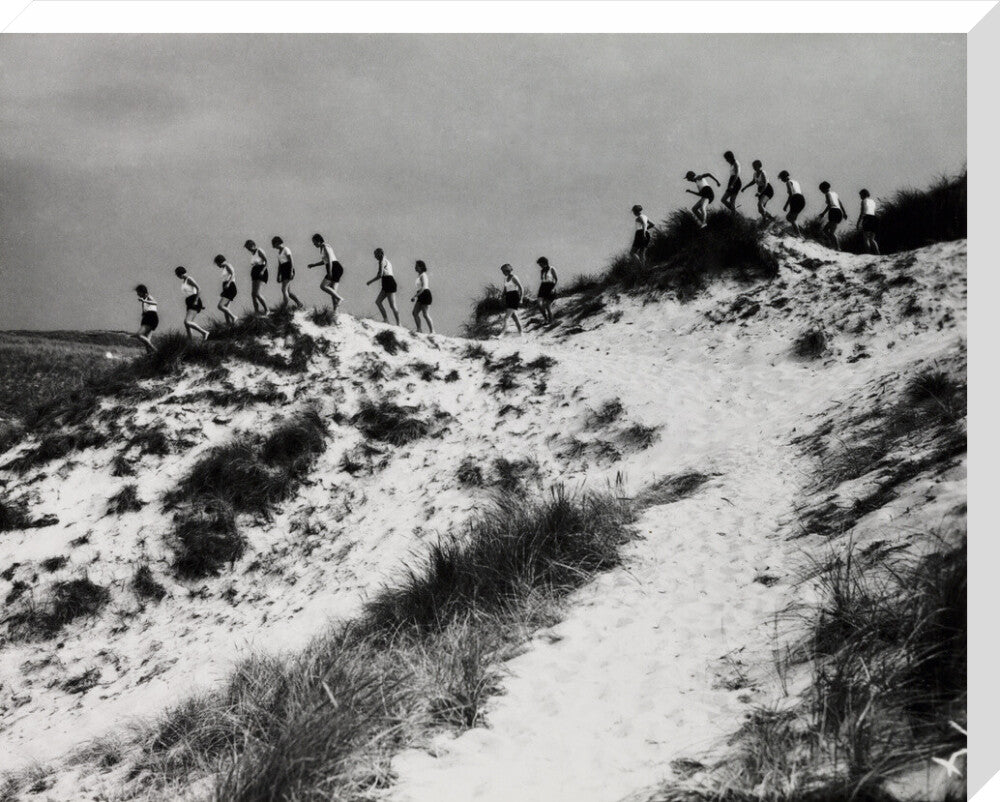 Horizon line of women walking over dunes, about 1930. stretched canvas large none Art Print - Science Museum Shop