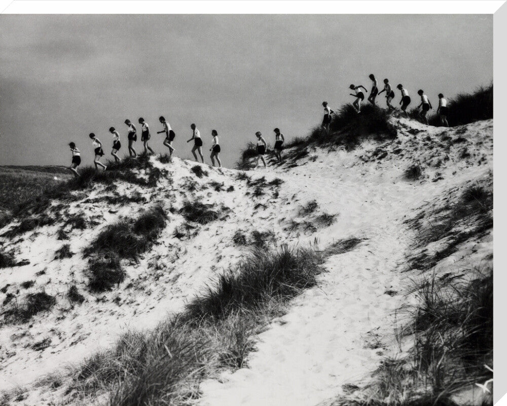Horizon line of women walking over dunes, about 1930. stretched canvas extra large none Art Print - Science Museum Shop