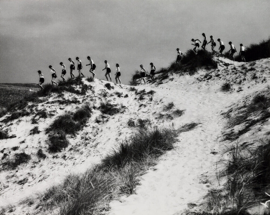 Horizon line of women walking over dunes, about 1930. Art Print - Science Museum Shop