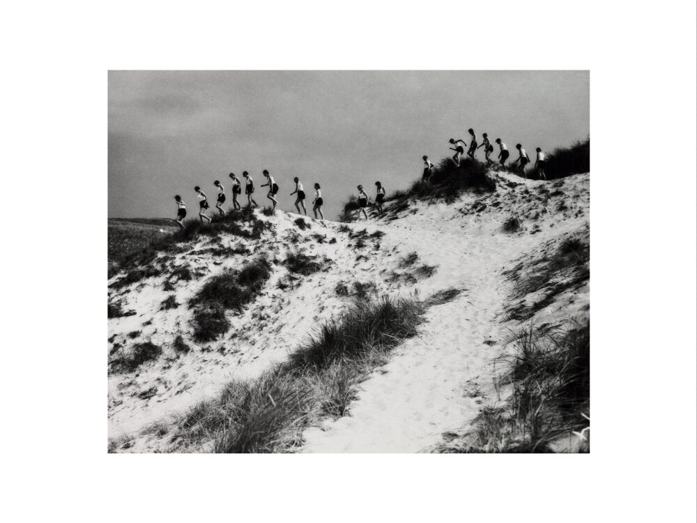 Horizon line of women walking over dunes, about 1930. art print small none Art Print - Science Museum Shop