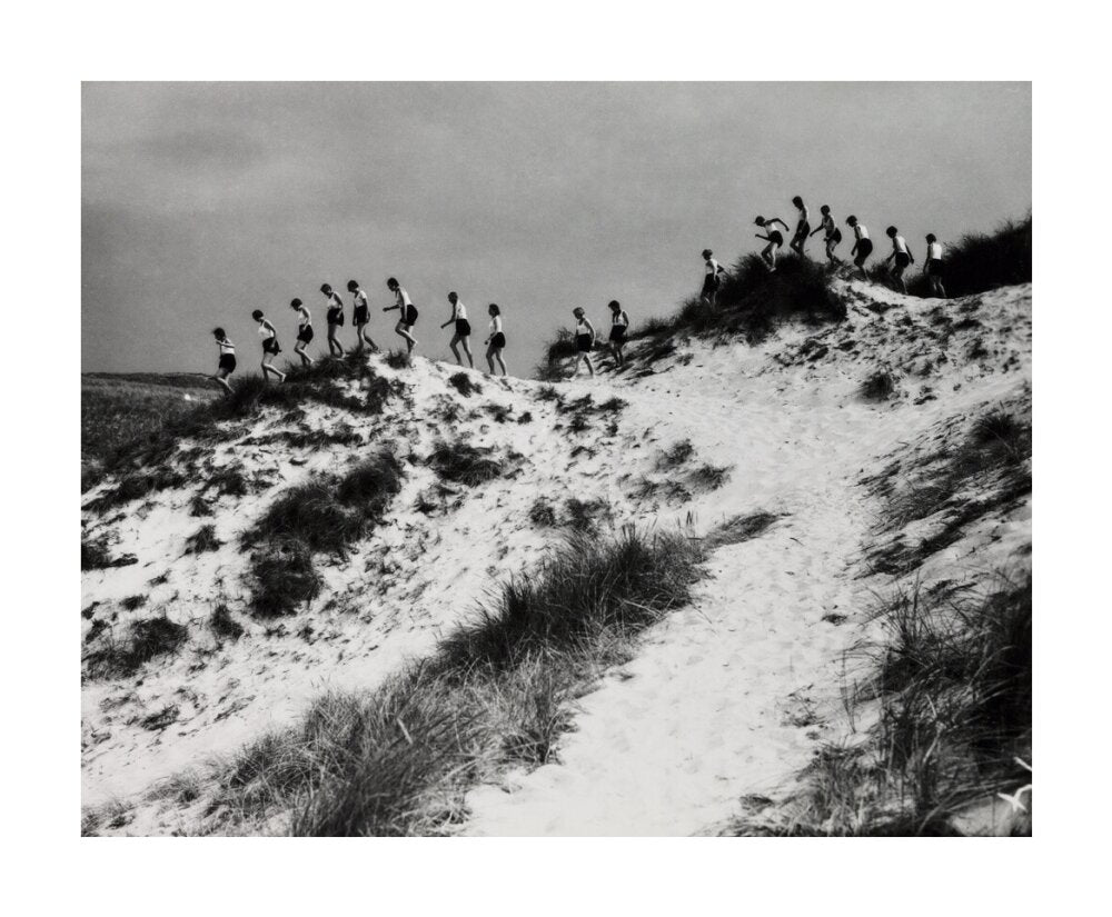 Horizon line of women walking over dunes, about 1930. unstretched canvas large none Art Print - Science Museum Shop